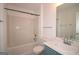 Bathroom features a bathtub, toilet, blue vanity, marble countertop, and large mirror at 5851 Giles Rd, Lithonia, GA 30058