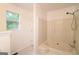Clean bathroom featuring a shower/tub combo and a window for natural light at 5851 Giles Rd, Lithonia, GA 30058