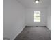 Carpeted bedroom featuring a window providing natural light at 5851 Giles Rd, Lithonia, GA 30058