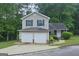 Charming two-story home with a two-car garage and beautiful, lush landscaping at 5851 Giles Rd, Lithonia, GA 30058