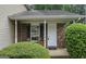 A cozy brick front porch with green shrubbery around the house at 5851 Giles Rd, Lithonia, GA 30058
