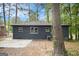 Backyard view of house with newer windows, patio, and lush trees at 2952 Diana Sw Dr, Atlanta, GA 30315
