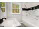 Elegant bathroom with a soaking tub, stylish tile, and a modern vanity with sleek fixtures at 2952 Diana Sw Dr, Atlanta, GA 30315