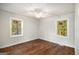 Inviting bedroom with hardwood floors, ceiling fan, and an abundance of natural light from two windows at 2952 Diana Sw Dr, Atlanta, GA 30315