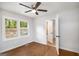 Bright bedroom with hardwood floors, ceiling fan, and a view of the backyard through the window at 2952 Diana Sw Dr, Atlanta, GA 30315