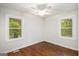 Cozy bedroom with hardwood floors, ceiling fan, and natural light from two windows at 2952 Diana Sw Dr, Atlanta, GA 30315