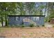 Charming home with charcoal painted brick, bright yellow stairs, mature trees, and nature views at 2952 Diana Sw Dr, Atlanta, GA 30315