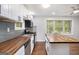 Bright kitchen featuring stainless steel appliances, butcher block countertops, white cabinets, and hardwood floors at 2952 Diana Sw Dr, Atlanta, GA 30315