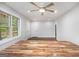 Bright living room featuring a modern ceiling fan, natural light, and sleek, wood-look floors at 2952 Diana Sw Dr, Atlanta, GA 30315
