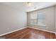 A bedroom with hardwood floors, a window for natural light, and neutral paint at 1360 Maple Valley Ct, Union City, GA 30291