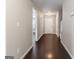 Long hallway featuring hardwood floors, neutral paint, and access to multiple rooms of the house at 1360 Maple Valley Ct, Union City, GA 30291