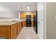 Efficient kitchen layout with light wood cabinets, modern black appliances, and neutral countertops at 1360 Maple Valley Ct, Union City, GA 30291