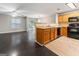 Open-concept kitchen featuring wood cabinets, modern appliances, and seamless flow to the living room at 1360 Maple Valley Ct, Union City, GA 30291