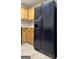 Practical kitchen featuring a black refrigerator, wood cabinets, and ample counter space for meal preparation at 1360 Maple Valley Ct, Union City, GA 30291