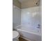 Clean bathroom featuring a white tiled tub and shower with chrome fixtures at 288 Country Club Dr, Jonesboro, GA 30238