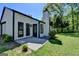 Exterior view showing the home's siding, a chimney, patio, and well-kept lawn at 3336 Country Creek Nw Dr, Kennesaw, GA 30152