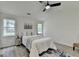 Bright bedroom with two windows, ceiling fan, decorative rug, and a neutral color scheme at 3336 Country Creek Nw Dr, Kennesaw, GA 30152