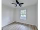 Well-lit bedroom with ceiling fan and window offering natural light at 3336 Country Creek Nw Dr, Kennesaw, GA 30152