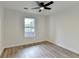 Bedroom with vinyl flooring, window, and ceiling fan provides a comfortable space at 3336 Country Creek Nw Dr, Kennesaw, GA 30152