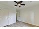 Bright bedroom with white walls, modern ceiling fan, and wood-look laminate flooring at 3336 Country Creek Nw Dr, Kennesaw, GA 30152