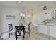 Light-filled dining area with modern lighting and seating, open to kitchen at 3336 Country Creek Nw Dr, Kennesaw, GA 30152