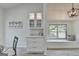 Bright dining area featuring custom cabinetry, a cozy window seat, and modern light fixtures at 3336 Country Creek Nw Dr, Kennesaw, GA 30152