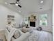 Inviting living room featuring a fireplace, ceiling fan, and neutral decor at 3336 Country Creek Nw Dr, Kennesaw, GA 30152