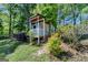A small outbuilding with a porch is surrounded by lush trees and greenery at 3336 Country Creek Nw Dr, Kennesaw, GA 30152