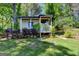 Charming outbuilding with porch nestled in trees with lush landscaping at 3336 Country Creek Nw Dr, Kennesaw, GA 30152