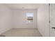 Bedroom with neutral carpet, single window and white trim and doors at 100 Silver Moon Dr, Loganville, GA 30052