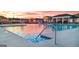 View of the community pool at sunset with splash fountains and lounge chairs at 100 Silver Moon Dr, Loganville, GA 30052