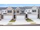 Modern townhomes featuring brick and siding exteriors and attached two-car garages at 100 Silver Moon Dr, Loganville, GA 30052
