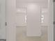 Hallway featuring two open doorways leading into rooms, with neutral carpet and trim at 100 Silver Moon Dr, Loganville, GA 30052