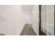 Bright hallway featuring hardwood floors, neutral walls, and multiple doors leading to various rooms at 100 Silver Moon Dr, Loganville, GA 30052