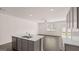 Open kitchen boasts an island with sink and dishwasher, opening to living space at 100 Silver Moon Dr, Loganville, GA 30052
