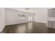 Open-concept living area with hardwood floors, ceiling fan, and an abundance of natural light at 100 Silver Moon Dr, Loganville, GA 30052