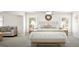 Bright bedroom with sitting area and ceiling fan in neutral color palette at 799 Grande Bishop Dr, Fairburn, GA 30213