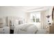 Bedroom features a large window, neutral colors, and a dresser at 799 Grande Bishop Dr, Fairburn, GA 30213