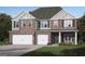 Beautiful two-story home boasting a brick facade, two-car garage, and a well-manicured lawn at 799 Grande Bishop Dr, Fairburn, GA 30213