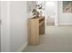Bright hallway with modern console table and decorative vase near the bathroom entry at 799 Grande Bishop Dr, Fairburn, GA 30213