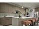 Modern kitchen with stainless steel appliances, sleek cabinets, a marble backsplash, and a center island with seating at 799 Grande Bishop Dr, Fairburn, GA 30213