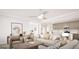 Bright, open-concept living room featuring hardwood floors, neutral tones, and seamless kitchen access at 799 Grande Bishop Dr, Fairburn, GA 30213