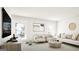 Bright living room features a neutral color palette, with two armchairs, white couch, and stylish round coffee table at 799 Grande Bishop Dr, Fairburn, GA 30213