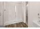 Tiled shower with glass doors and wooden flooring at 322 Sound Cir # 118, Stockbridge, GA 30281
