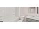 Bright bathroom with tub and shower combination, modern vanity, and commode at 322 Sound Cir # 118, Stockbridge, GA 30281