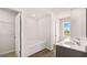 Bathroom featuring double sinks, and a separate bathtub with storage closet at 322 Sound Cir # 118, Stockbridge, GA 30281