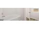 Bathroom showcasing a built-in tub, and a window view at 322 Sound Cir # 118, Stockbridge, GA 30281