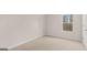 Bedroom view with a window and neutral carpeting and walls at 322 Sound Cir # 118, Stockbridge, GA 30281