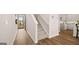 Welcoming entryway leading to the staircase and an open-concept kitchen with luxury vinyl flooring at 322 Sound Cir # 118, Stockbridge, GA 30281