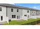 A long view of a townhome complex highlighting its grass lawn and black metal fence at 322 Sound Cir # 118, Stockbridge, GA 30281